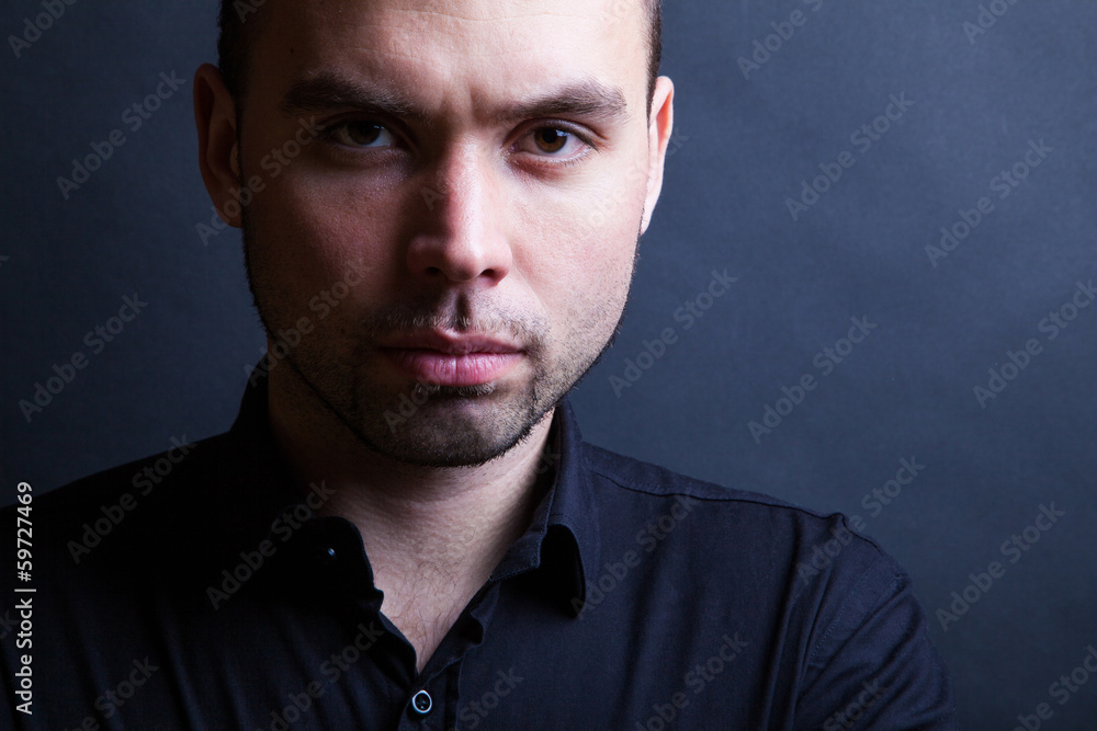 Obraz premium Young handsome man with serious expression