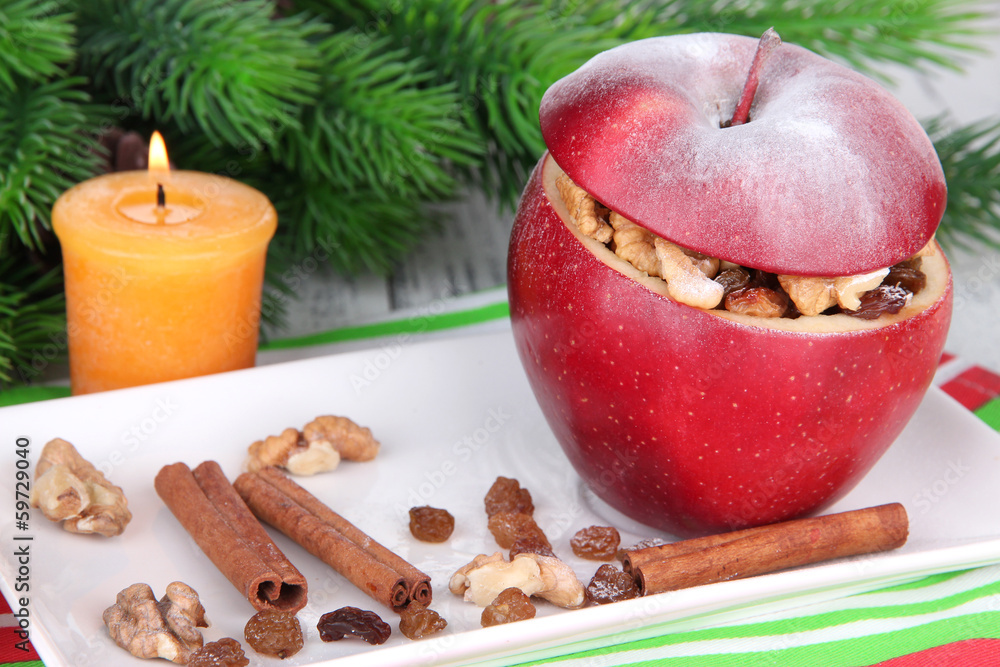 Stuffed Christmas apple with nuts and raisins on table close up Stuffed Christmas apple with nuts and raisins on table close up