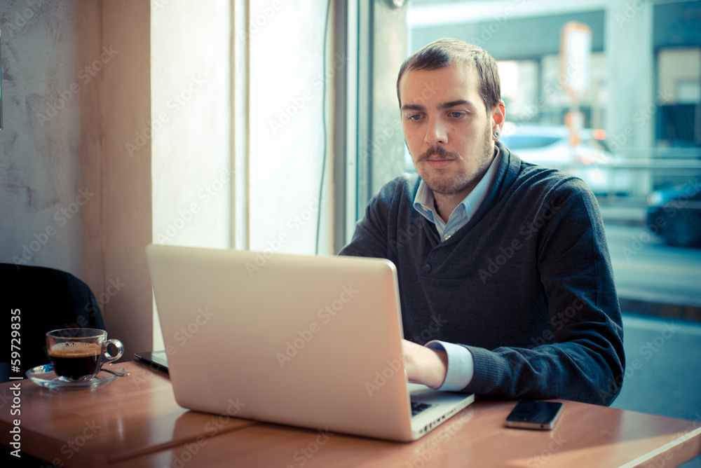 multitasking man using tablet, laptop and cellhpone multitasking man using tablet, laptop and cellhpone