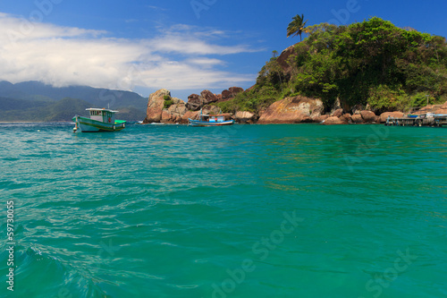Boat near beach Aventueiro of island Ilha Grande, Brazil photo