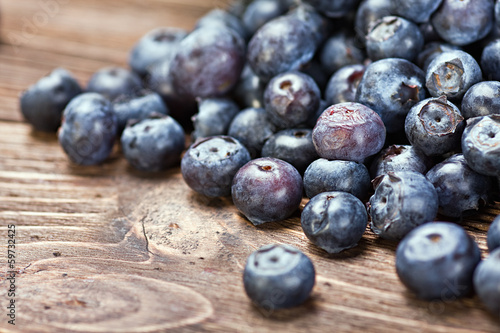 blueberries on old wooden table background. Shallow depth of fie