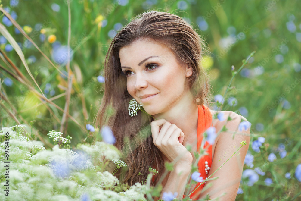 Beautiful young woman on the meadow with white flowers Beautiful young woman on the meadow with white flowers