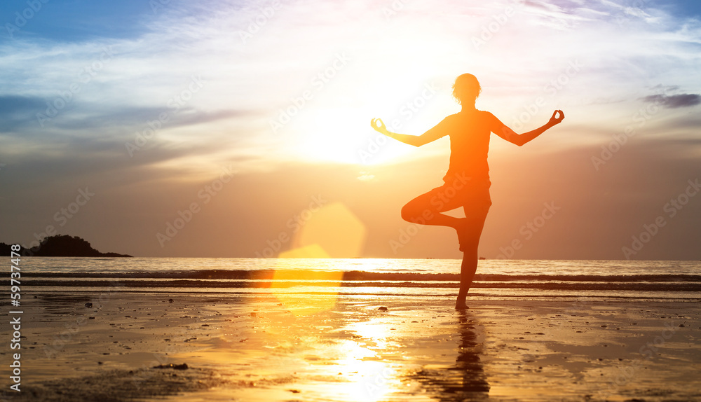 Silhouette of woman practicing yoga at sunset. Silhouette of woman practicing yoga at sunset.