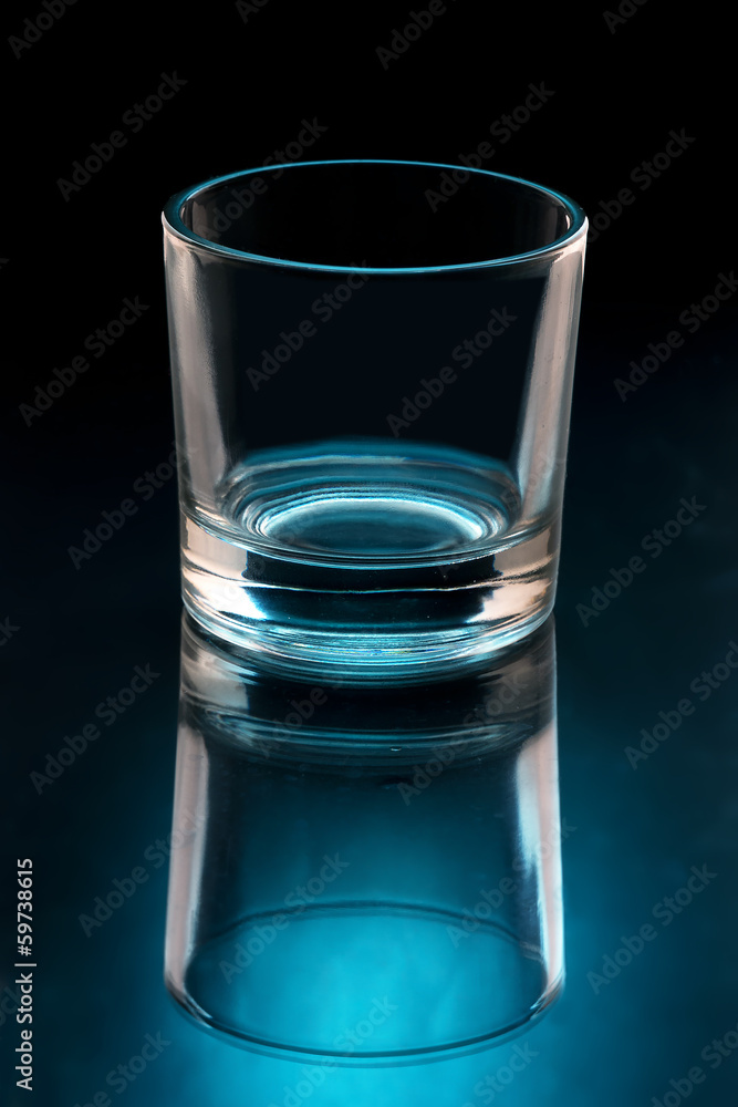 empty glass on black background illuminated empty glass on black background illuminated