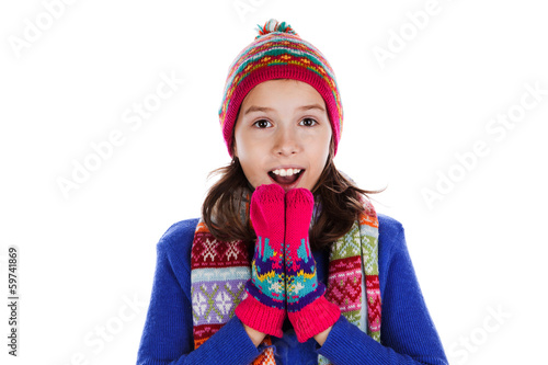 Beautiful little girl in cap and scarf