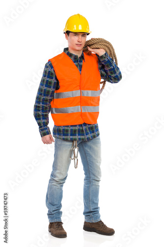 Construction worker in reflective clothing and holding rope.