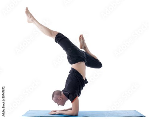 Flexible man posing in difficult yoga pose