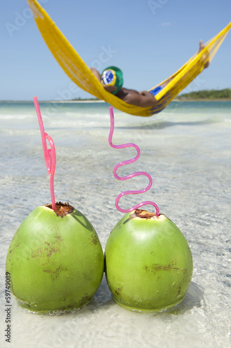 Man Relaxing in Hammock Brazilian Beach with Coconuts
