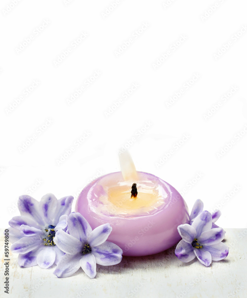 Scented candles and violet hyacinth flowers