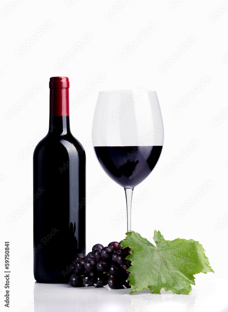 Bottle of wine next to wine glass, close-up