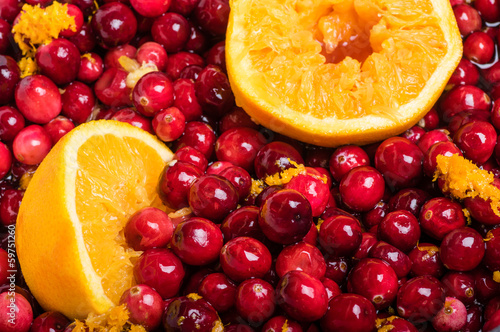 Cranberries and orange making cranberry sauce