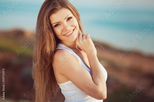 portrait of a woman on a background of mountains and sea