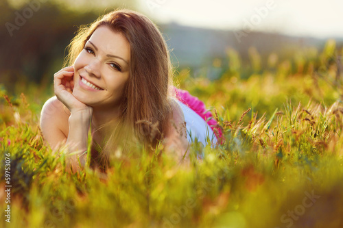portrait young woman on the meadow on a warm summer day