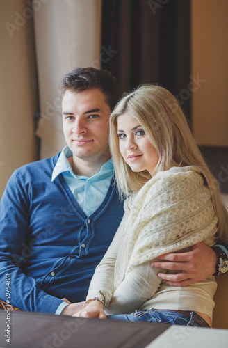 Romantic young couple embracing and having fun in the cafe