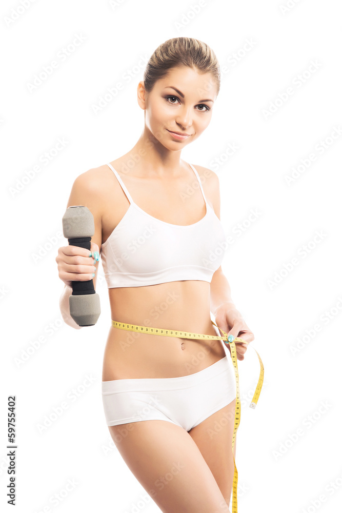 A young and fit woman training with a dumbbell on white A young and fit woman training with a dumbbell on white