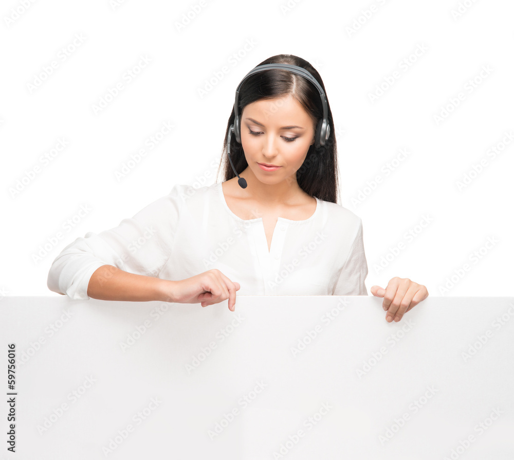 A young brunette businesswoman in headphones holding a banner A young brunette businesswoman in headphones holding a banner