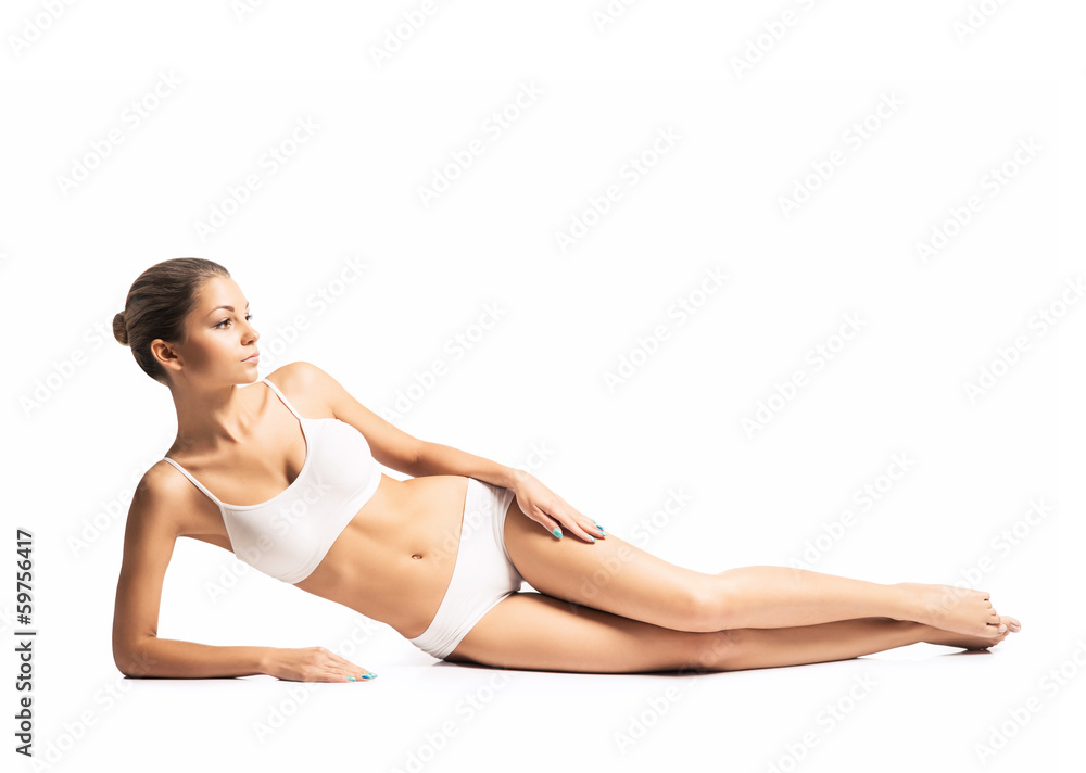A fit girl in lingerie isolated on a white background A fit girl in lingerie isolated on a white background