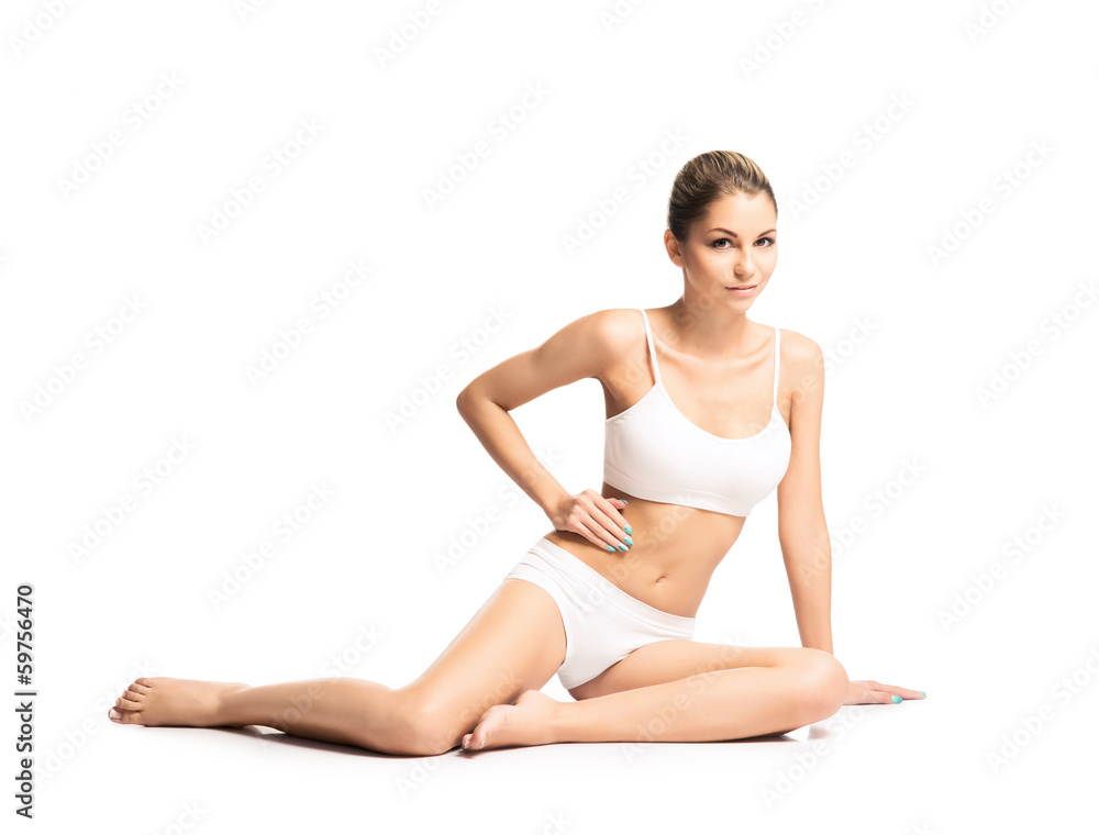A fit girl stretching in lingerie isolated on a white background A fit girl stretching in lingerie isolated on a white background
