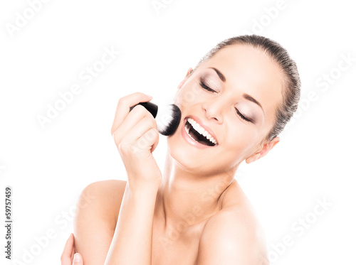 Beauty portrait of young, attractive woman with the makeup brush