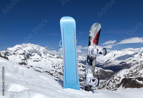 Two snowboard standing upright in snow
