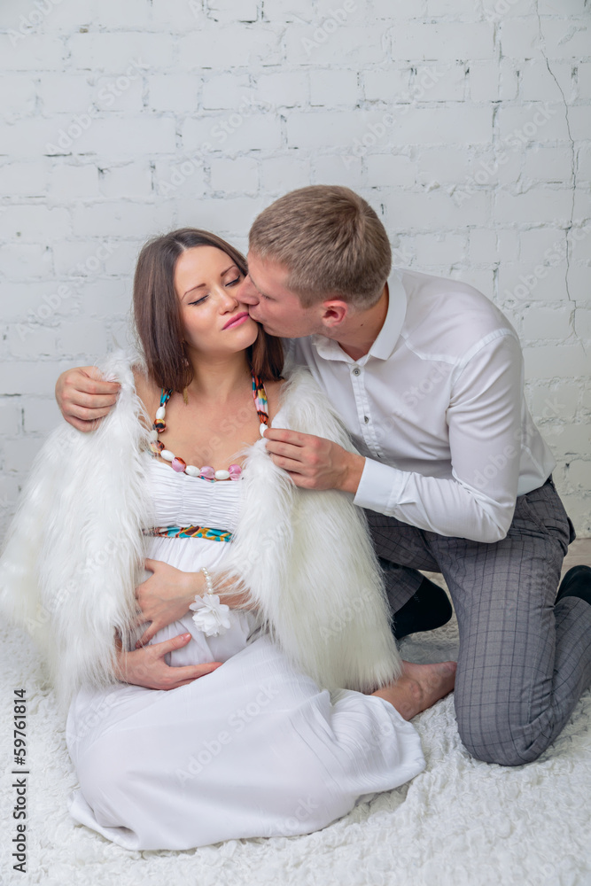 man is kissing his pregnant wife man is kissing his pregnant wife