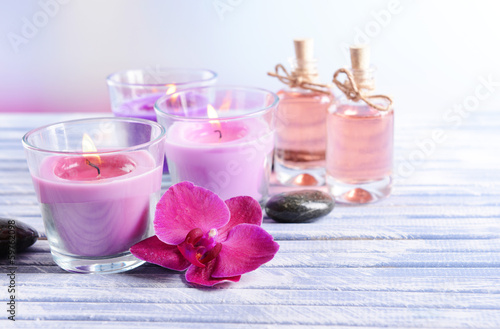 Beautiful colorful candles  spa stones and  orchid flower on