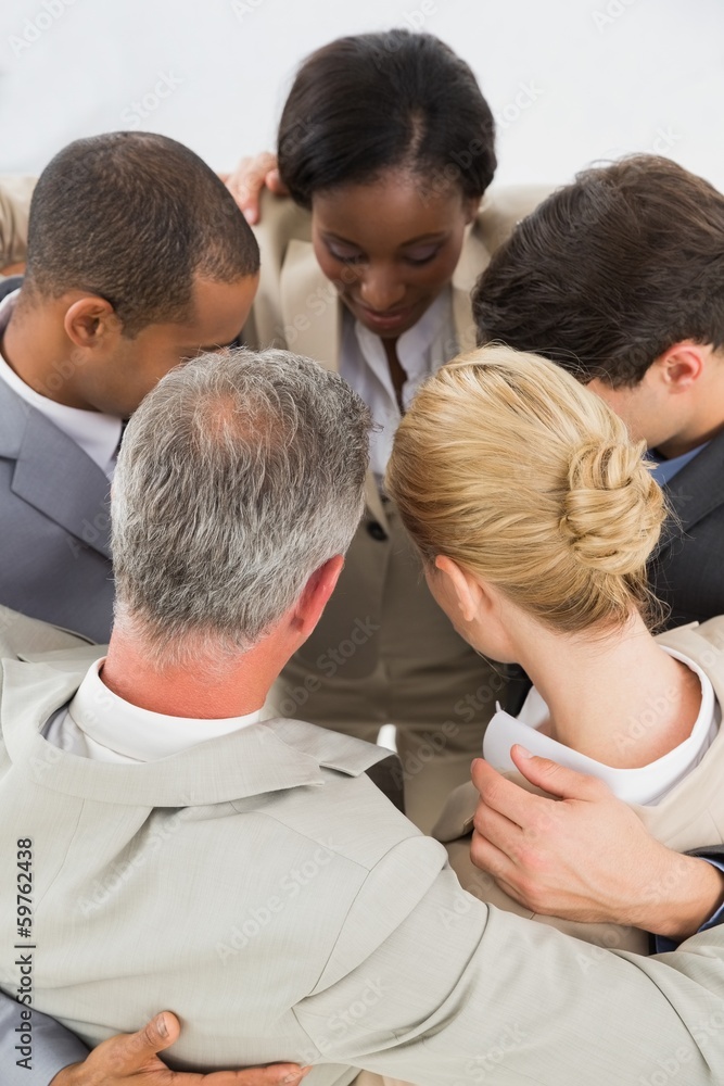 Close business team hugging in a circle Close business team hugging in a circle