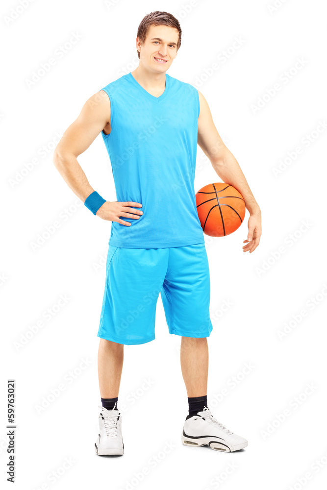 Full length portrait of a male basketball player holding a ball
