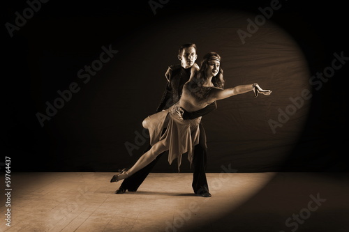 Latino dancers in ballroom isolated on black background