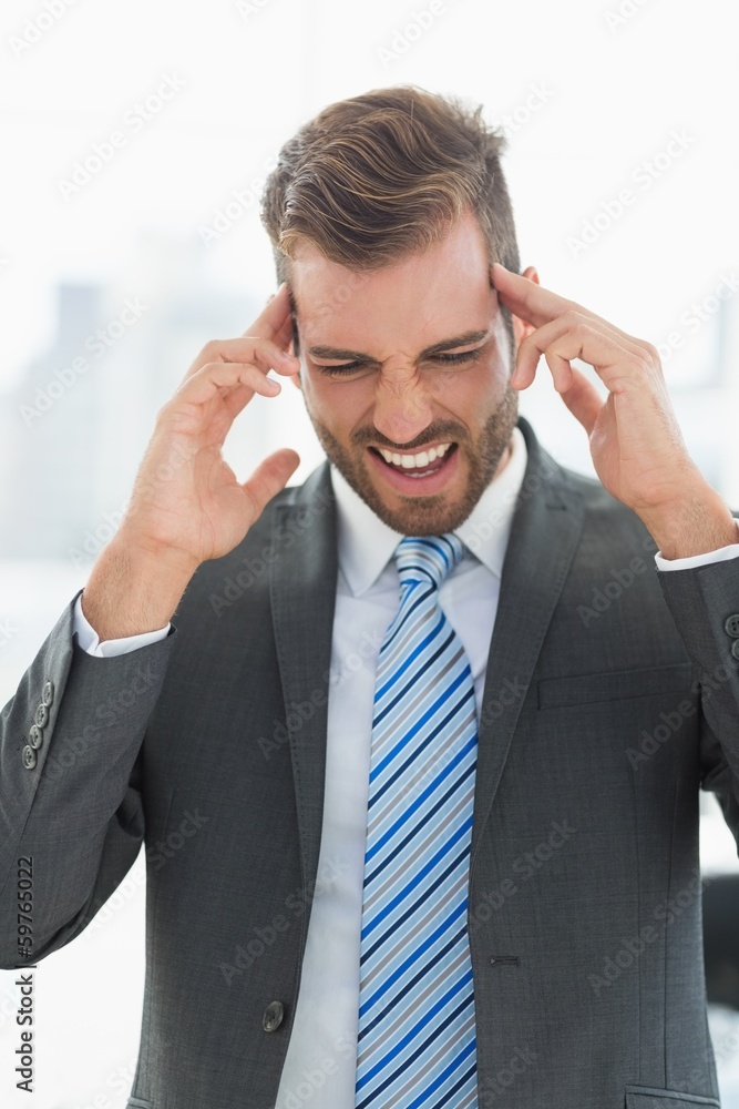 Close-up of a young businessman with headache Close-up of a young businessman with headache