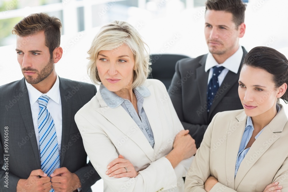 Confident and serious business team in office Confident and serious business team in office