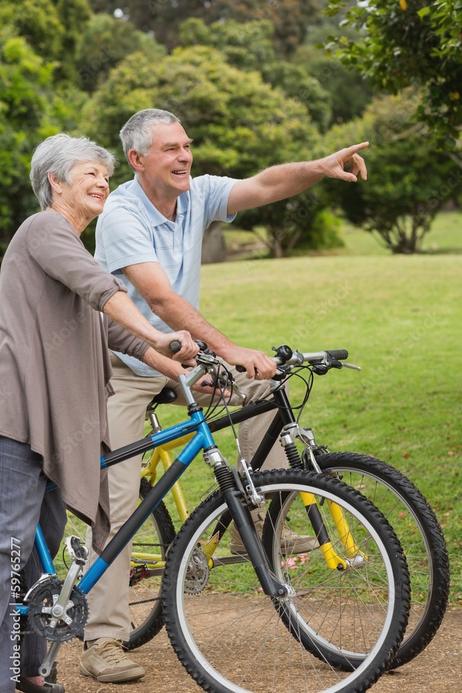 Obraz premium Senior couple on cycle ride in countryside