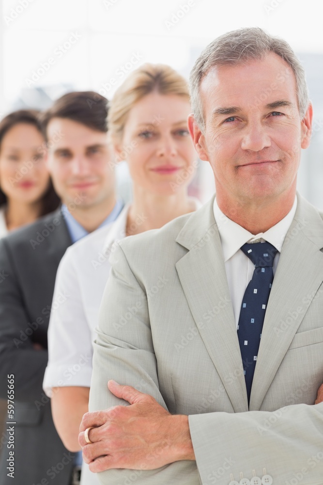 Business team standing in a line smiling at camera Business team standing in a line smiling at camera