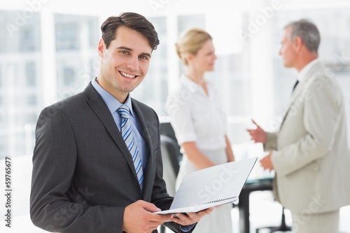 Wallpaper Mural Businessman reading over a document smiling at camera Torontodigital.ca