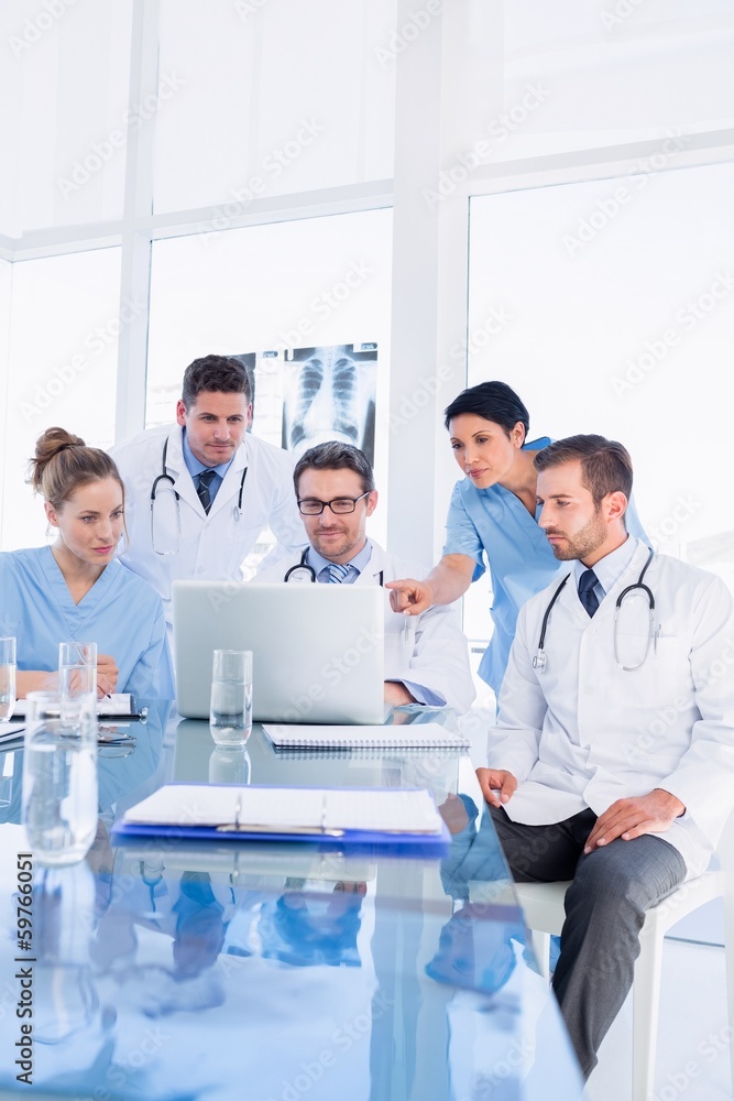 Fototapeta premium Concentrated medical team using laptop together