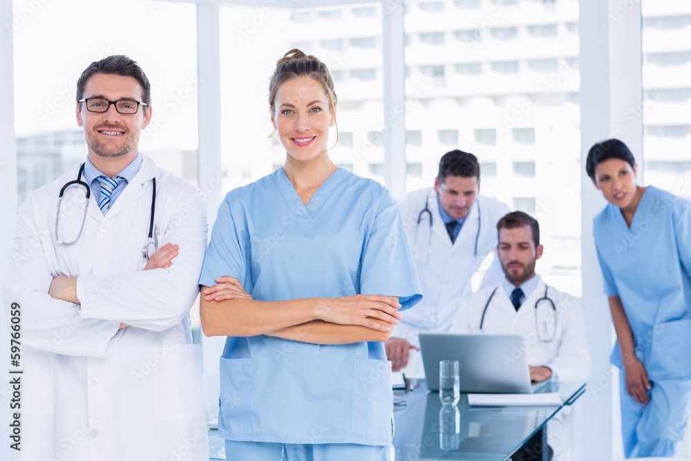 Doctors with colleagues using laptop in medical office Doctors with colleagues using laptop in medical office