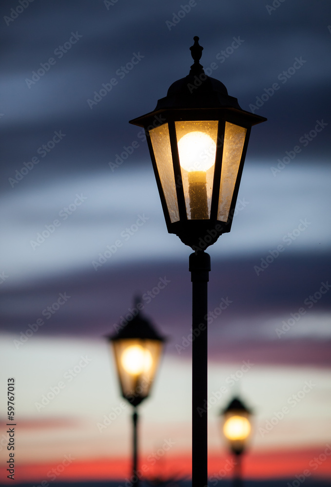 old lamps shining in sunset sky