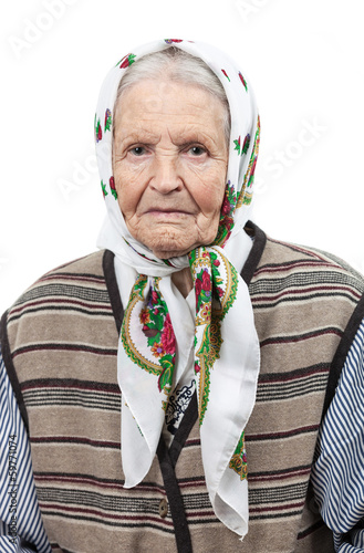 Portrait of a senior woman in headscarf looking at the camera photo
