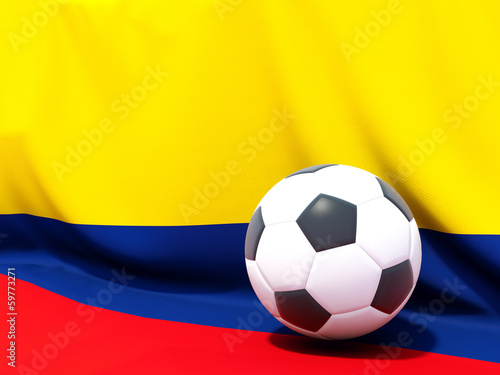 Flag of colombia with football in front of it
