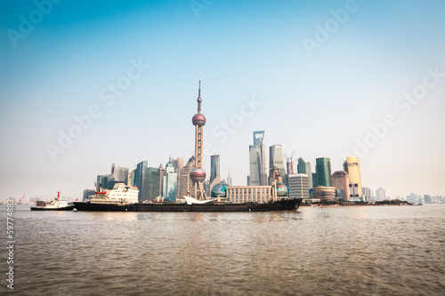 shanghai skyline and cargo ship