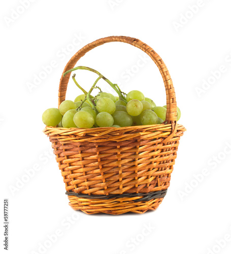 Grape bunch in small wicker basket isolated close up
