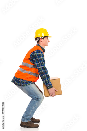 Photography Crouching with a heavy package.