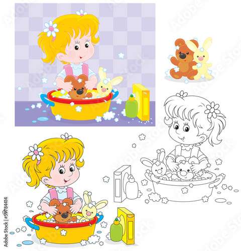 Little girl washing her toy bear and rabbit