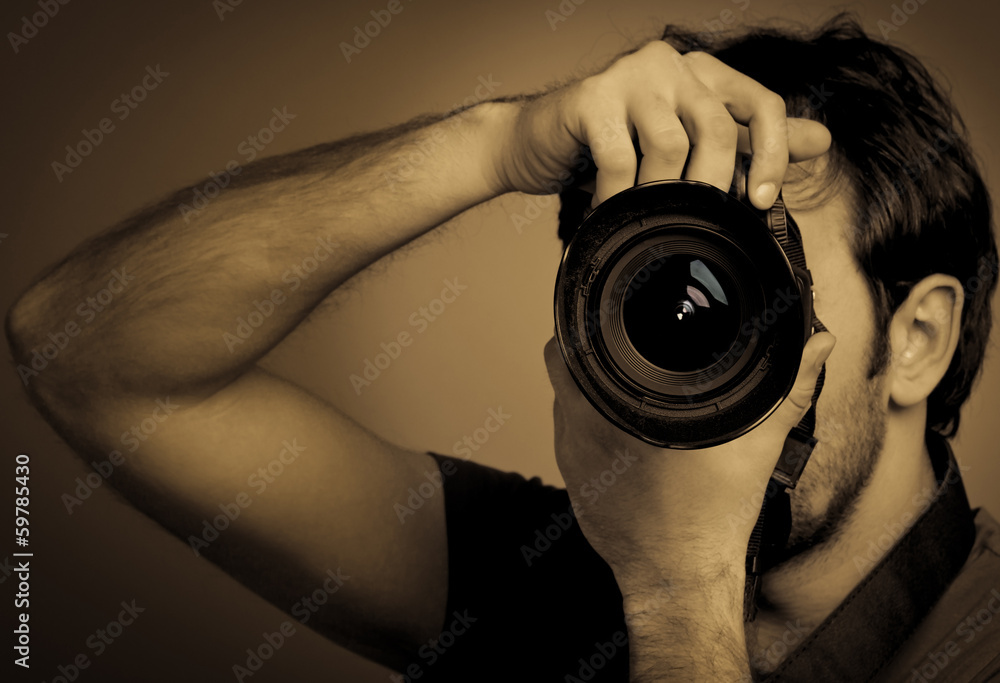 Young man with professional camera