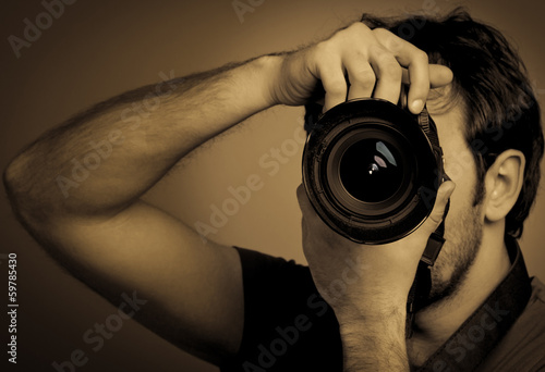 Obraz na płótnie Young man with professional camera w salonie
