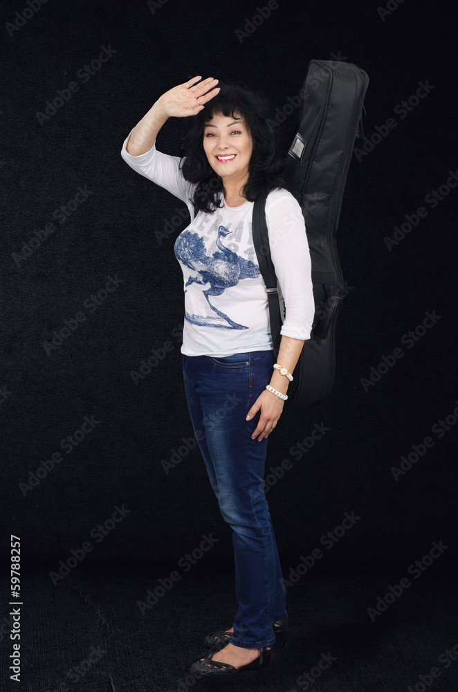 Woman guitarist on the dark grey background Woman guitarist on the dark grey background