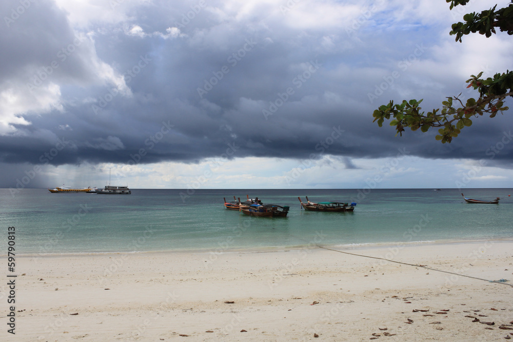 Fototapeta premium Longtail boats lined up before a storm