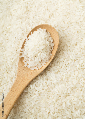 White rice on wooden teaspoon