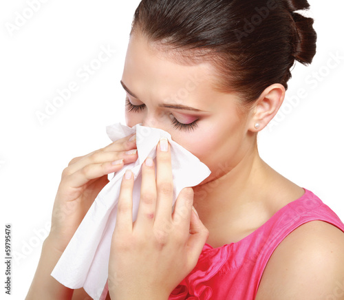 Sick woman blowing her nose, white background.