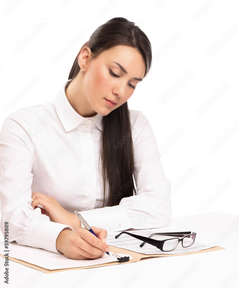 Young businesswoman signing documents at desk Young businesswoman signing documents at desk